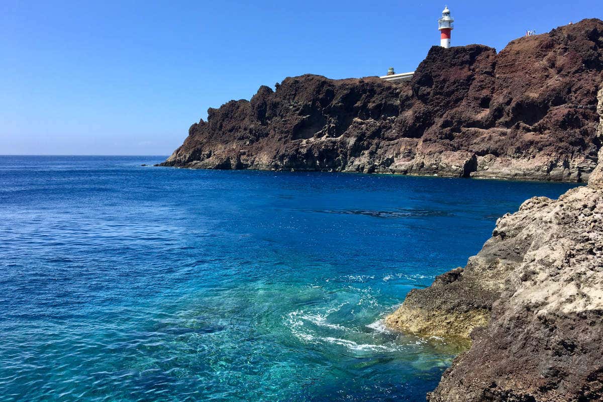 Coastal cliffs of Punta de Teno with the red and white lighthouse in the background.