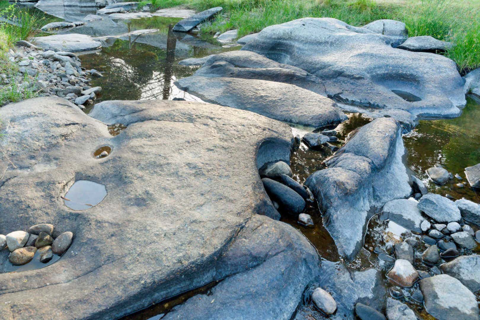 Varias piedras mojadas en el paso de un río