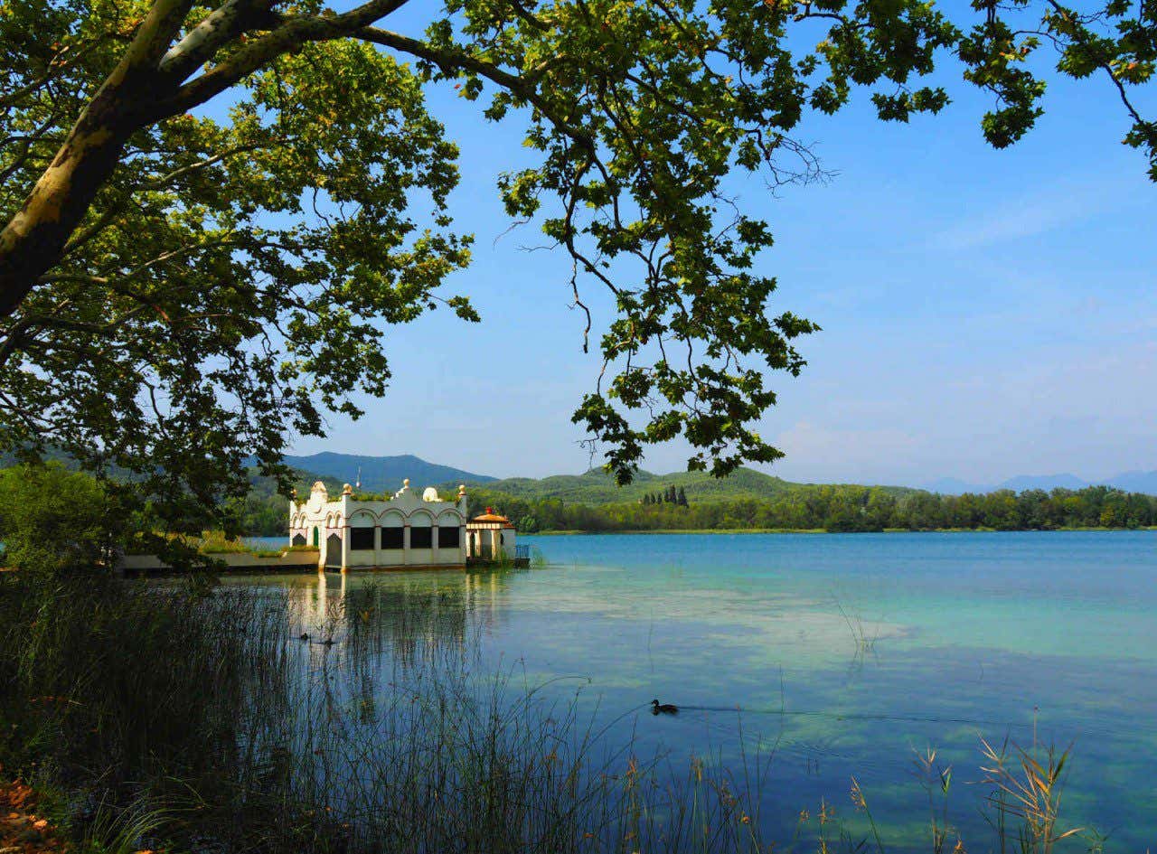 Vista del lago de Bañolas, en la provincia de Gerona, con pequeño embarcadero y varias colinas alrededor