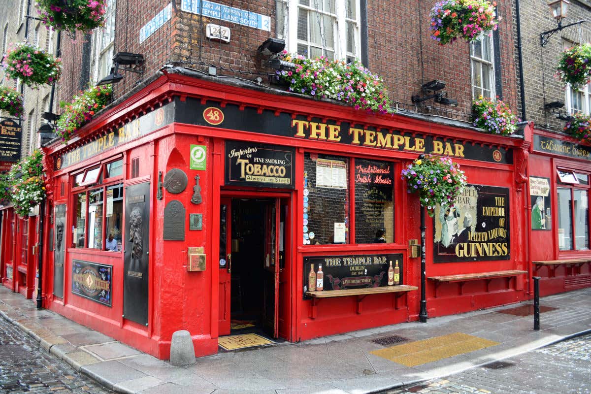 Façade rouge avec des fleurs au Temple Bar, l'un des pubs irlandais les plus célèbres du centre-ville de Dublin