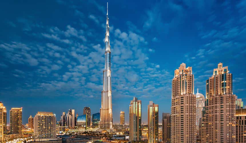 The Burj Khalifa towering above other skyscrapes in Dubai at sunset