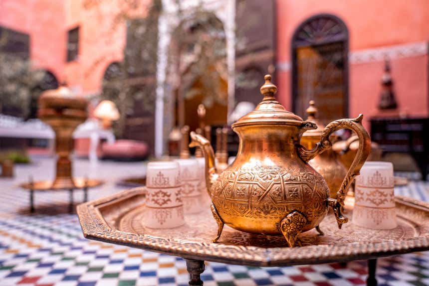 A tray with a Moroccan teapot and glasses for mint tea