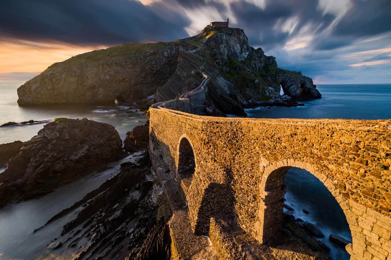 The bridge of San Juan de Gaztelugatxe leading to the hermitage on the island at sunset.