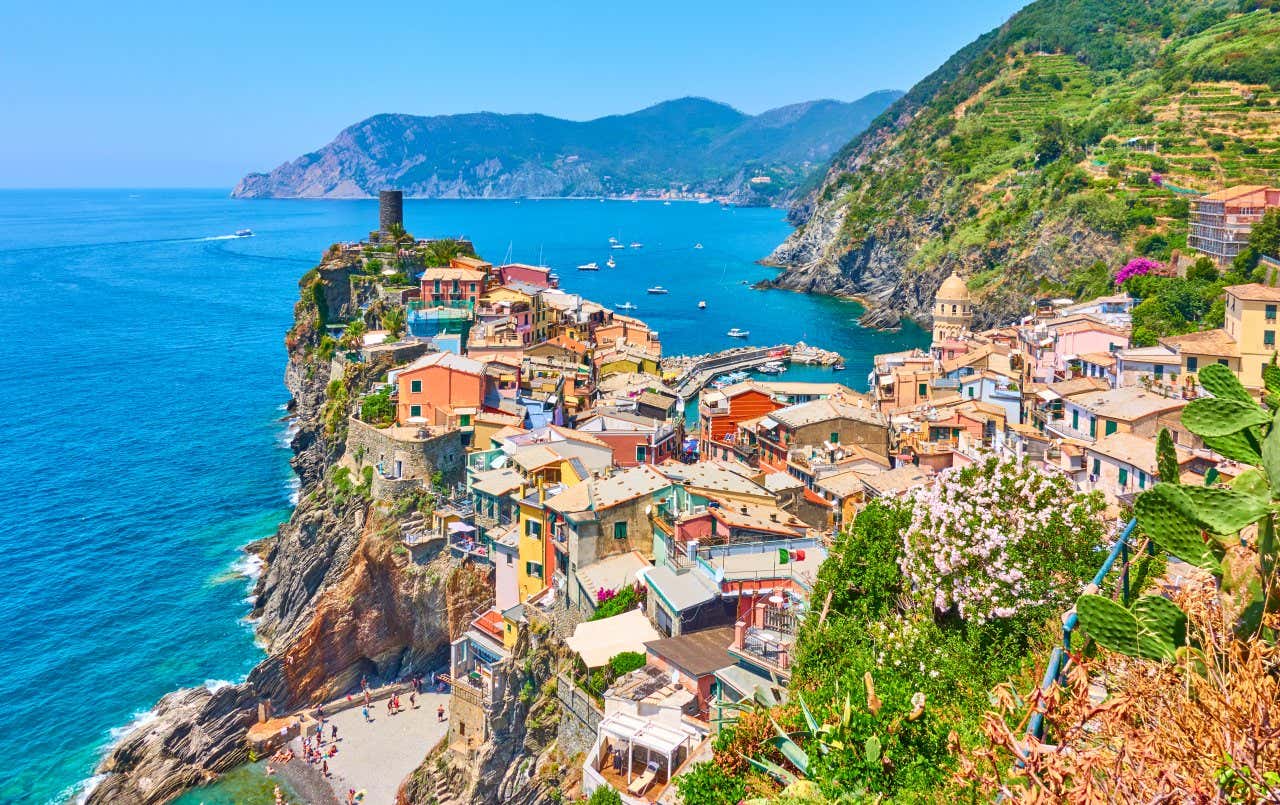 An aerial view of Cinque Terres in Italy, with the sea and a clear sky in view.