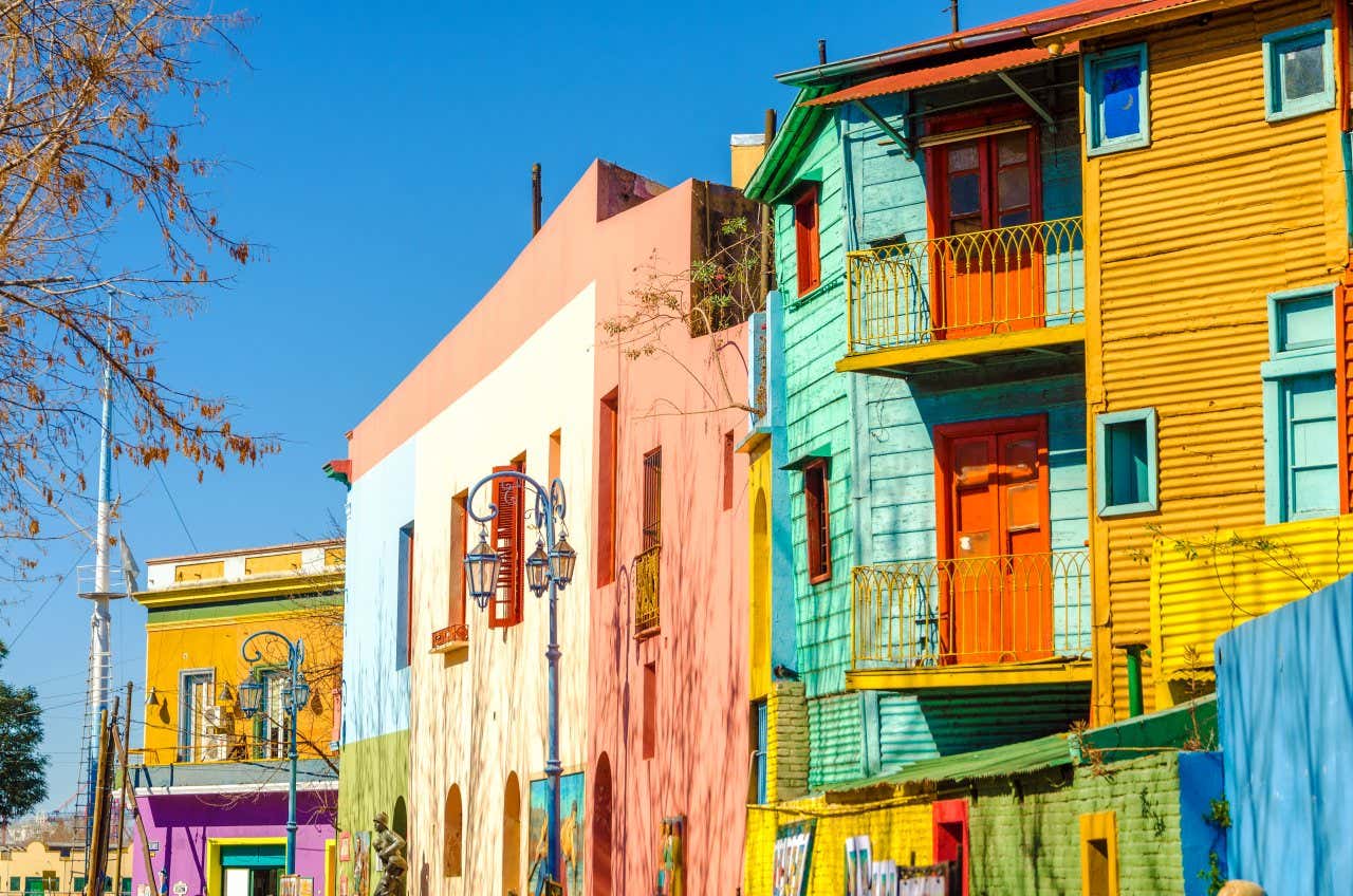 Calle Caminito in Buenos Aires, Argentina, with colourful buildings and a clear sky in view.