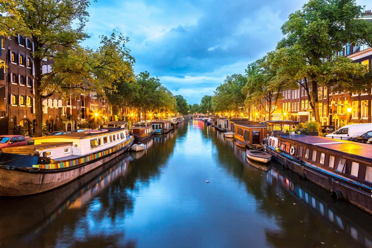 A shot of a canal in Amsterdam in the Netherlands on a cloudy day in the evening.