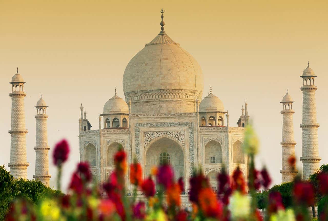 The Taj Mahal with flowers in the foreground.