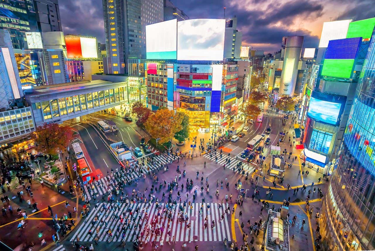 An aerial view of the famous crosswalk in Shibuya, Tokyo at night.