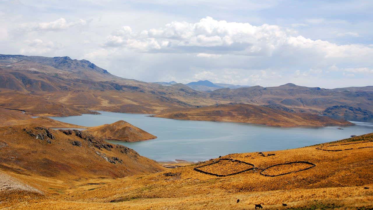 A panoramic view of the La Joya Desert in Arequipa, under a cloudy sky.