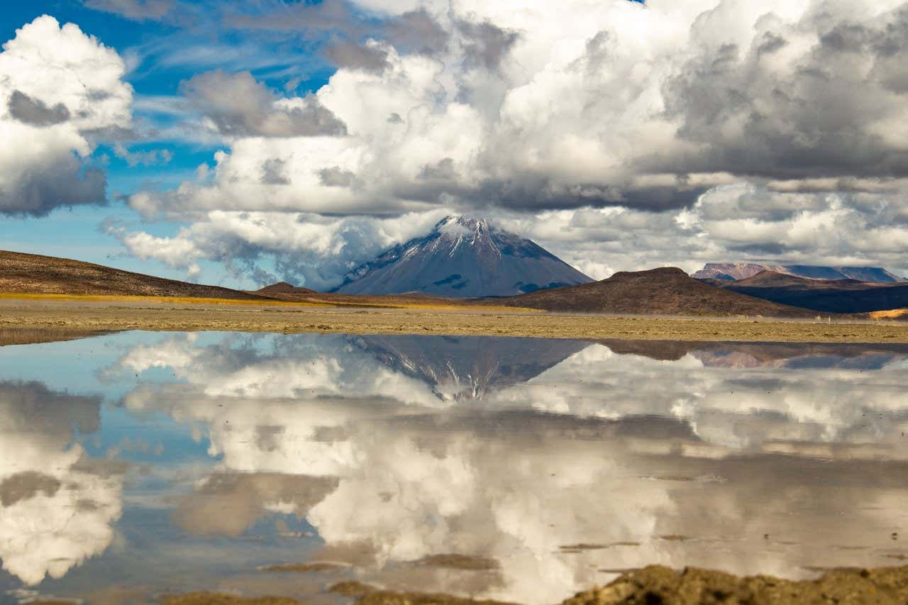 The Misti Volcano reflected in the Salinas Lagoon on a cloudy day.