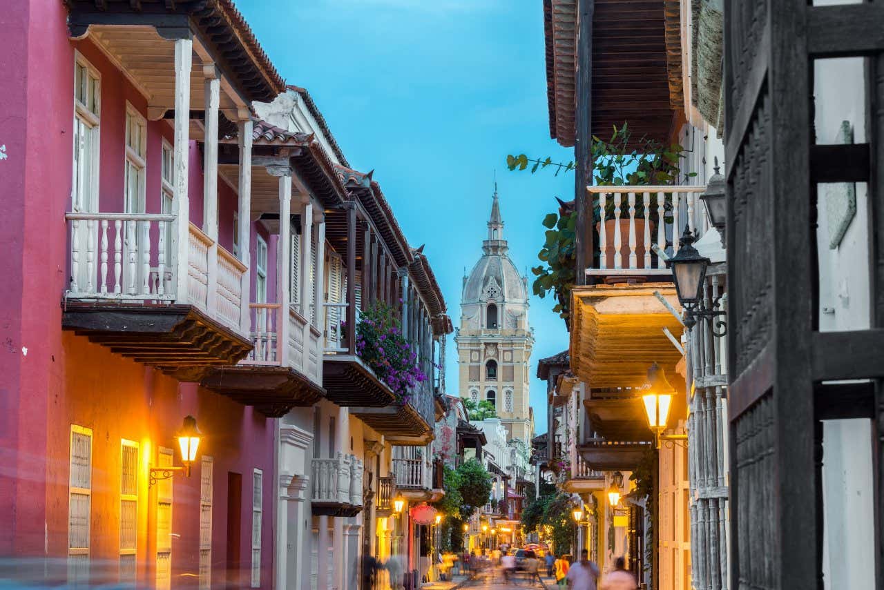 Street view of Cartagena, Colombia, after sunset, with the cathedral visible in the background