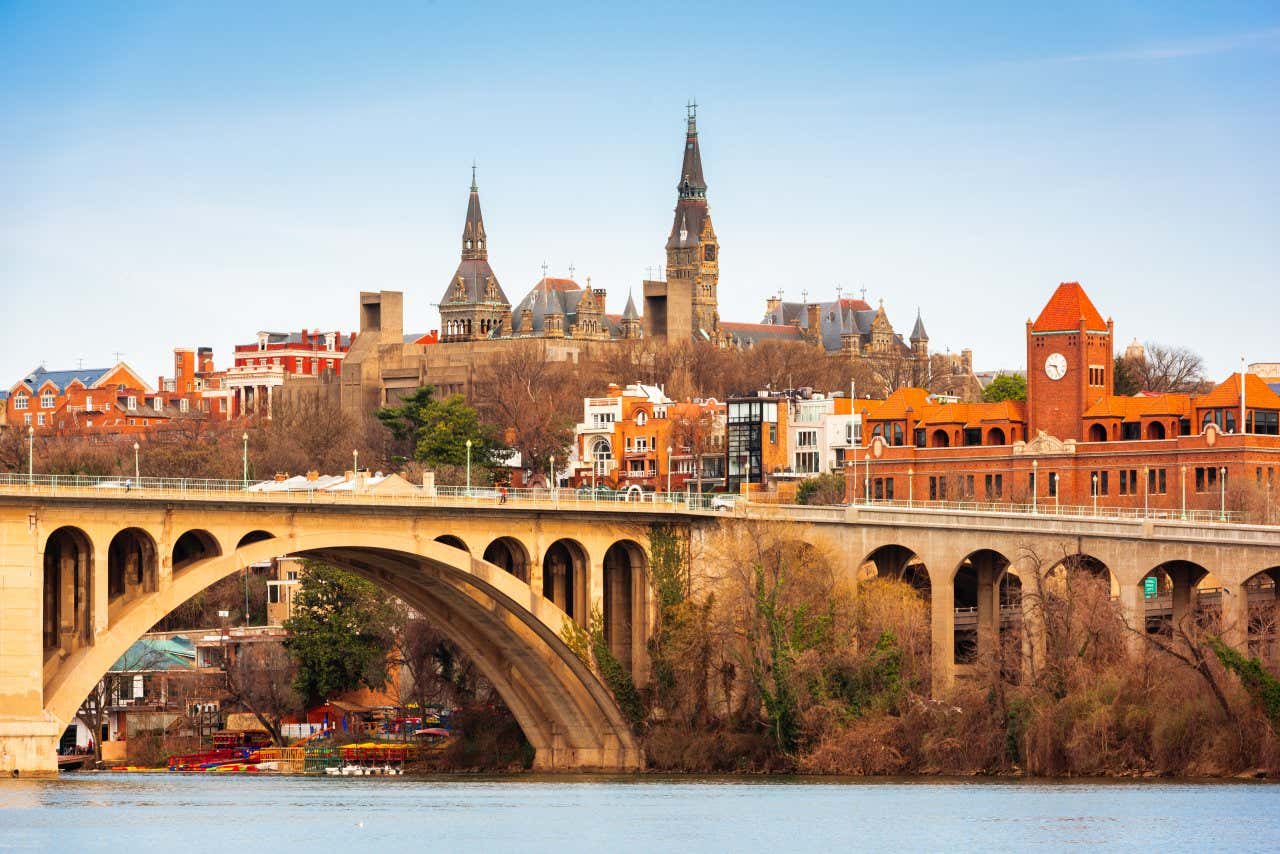 View of Georgetown, Washington, DC, from the river with a bridge and views of a church and towers