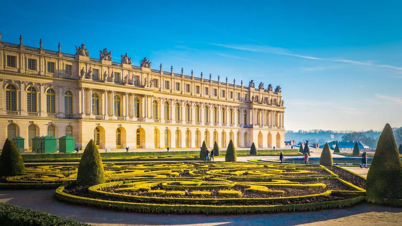 Lateral do Palácio de Versalhes com partes do jardim abaixo