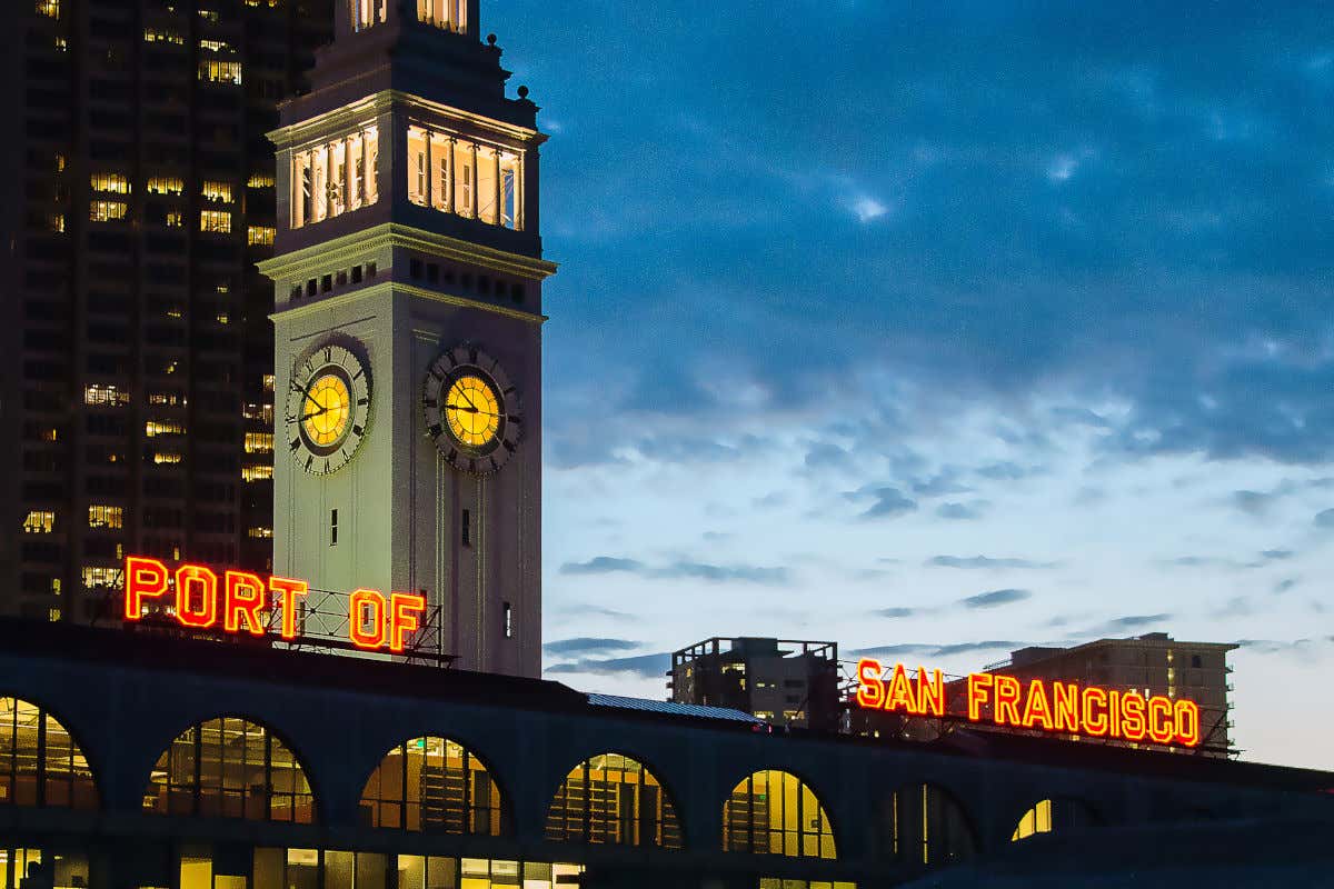 Night-lit clock tower of the Ferry Building in San Francisco Harbor.