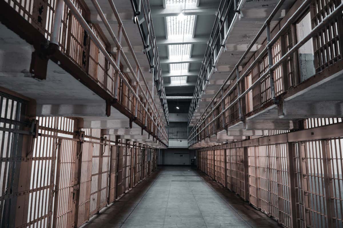 A passageway lined with barred cells inside San Francisco's Alcatraz prison.