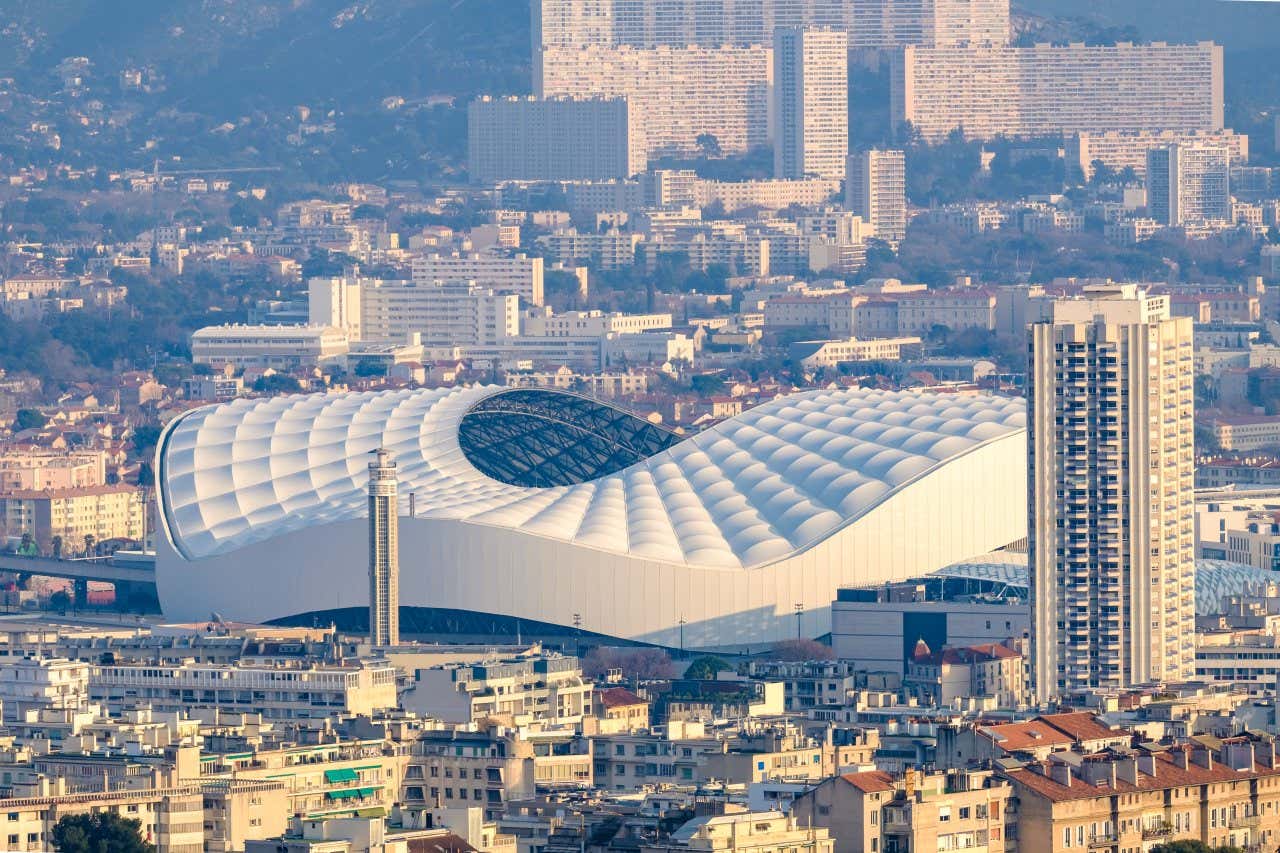 Marseille's Stade Vélodrome surrounded by pale high-rise buildings 