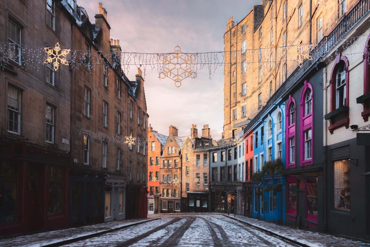 Victoria Street in Edinburgh during the winter, with Christmas decorations and snow in view.