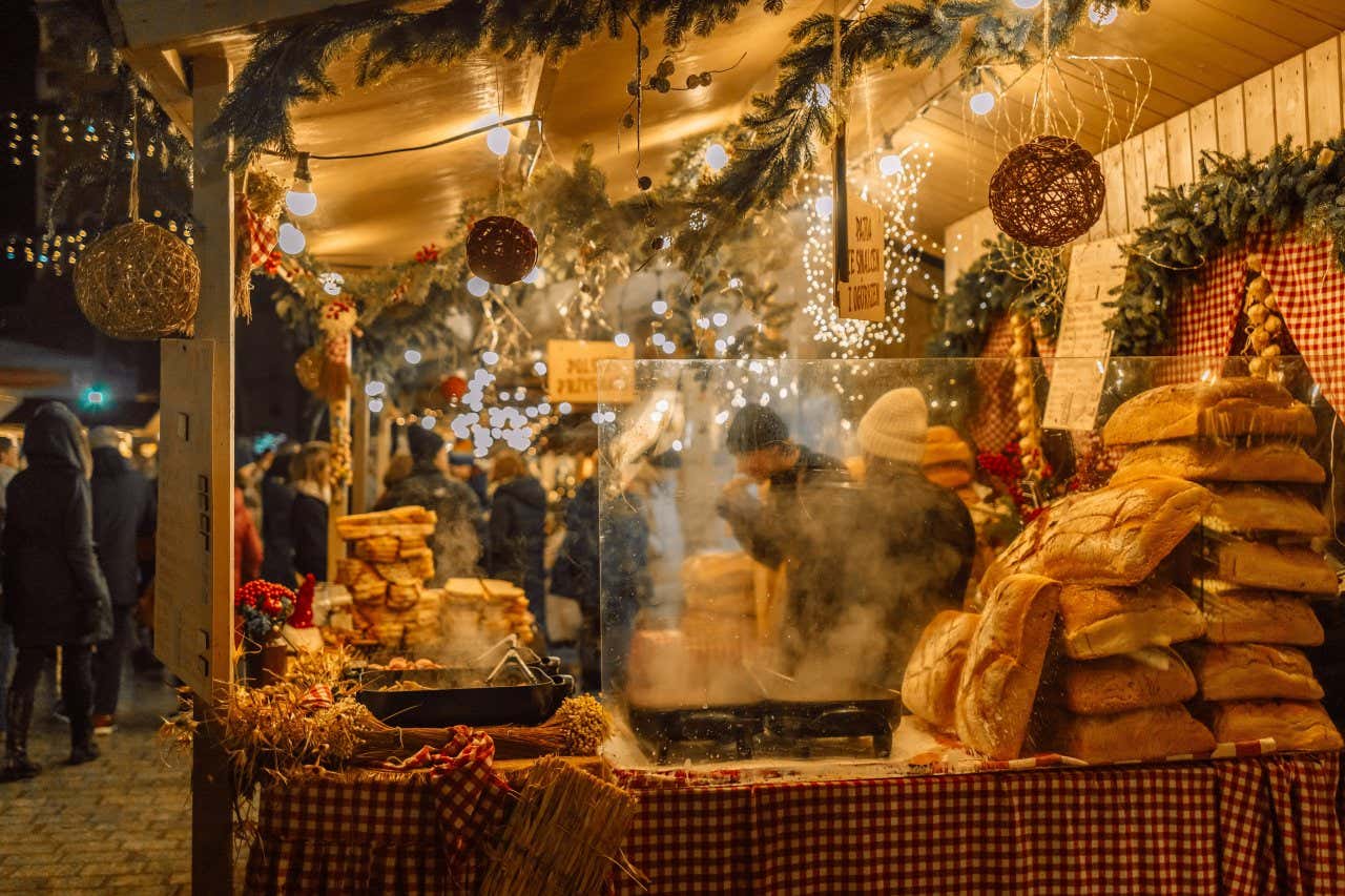 A Krakow food stall at night with Christmas decorations in shot.