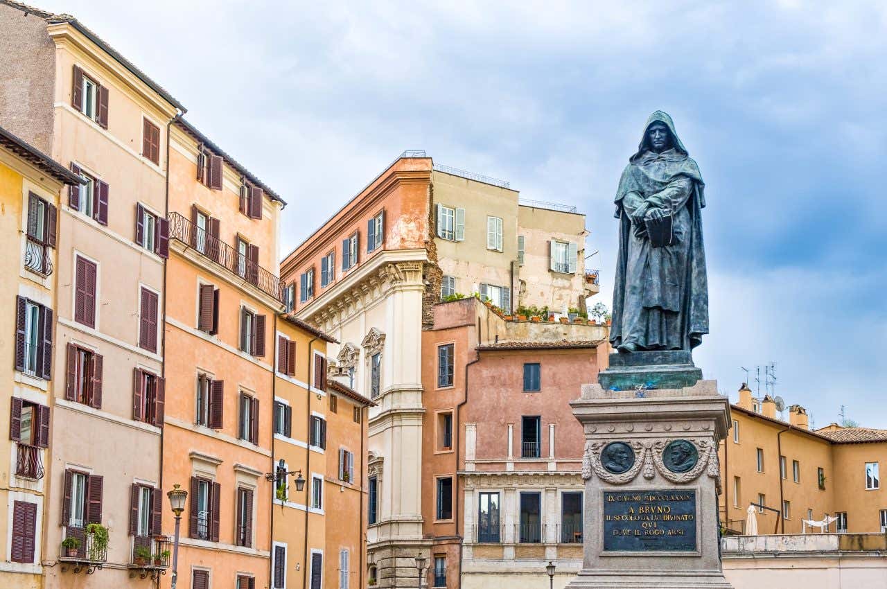 A view of the Giordano Bruno Statue in Campo de' Fiori under a cloudy sky.