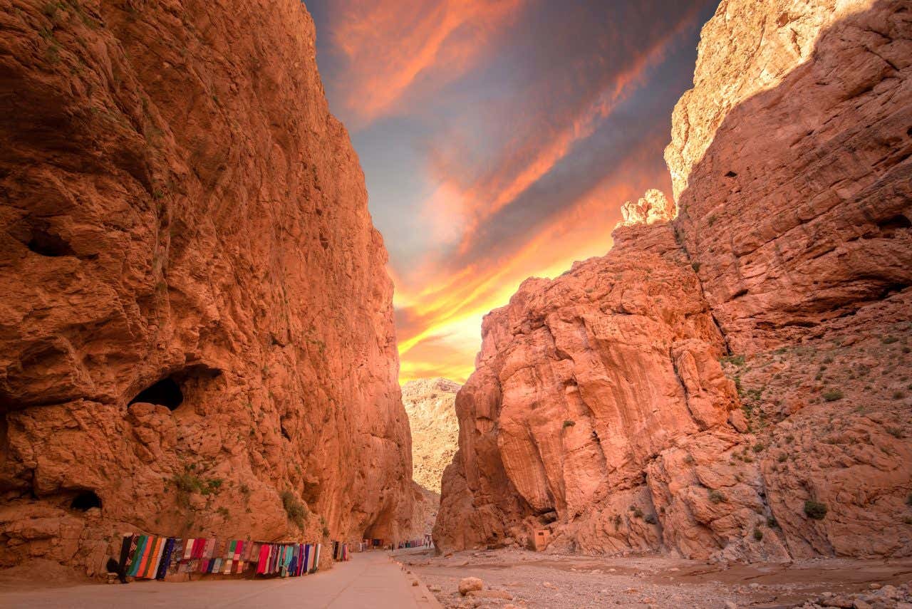 Des roches de l'Atlas formant un canyon, où sèchent des tapis