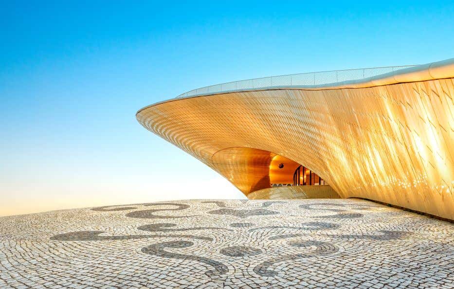 A view of the MAAT Museum in Lisbon under a clear blue sky.