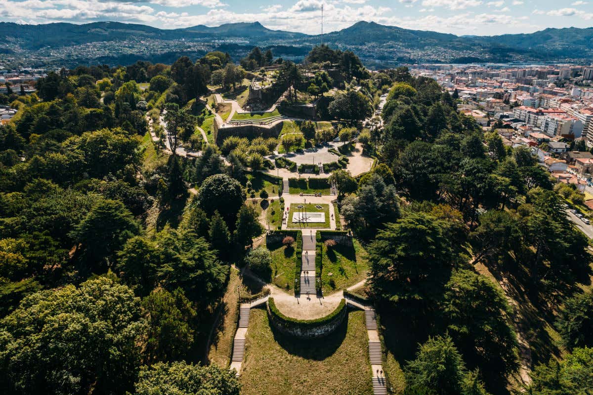 Aerial view of Monte O Castro in Bigo with many paths surrounded by trees 