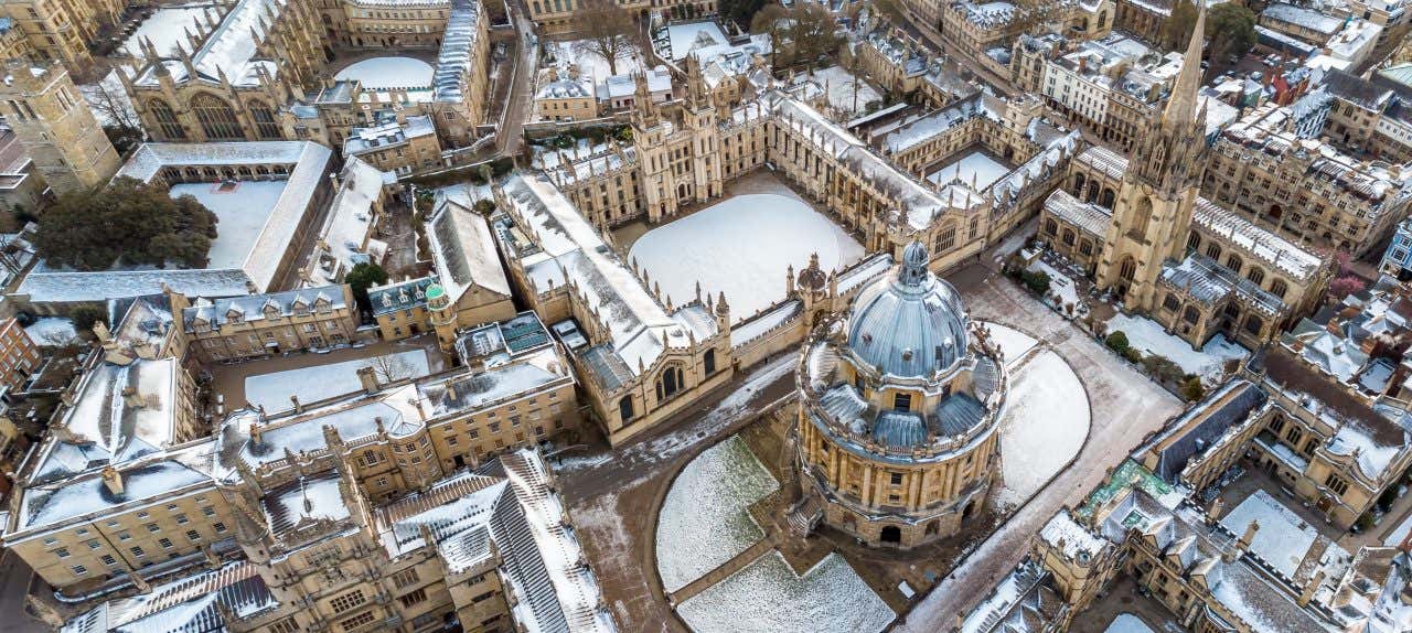 An aerial view of Oxford with snowy roofs and quads