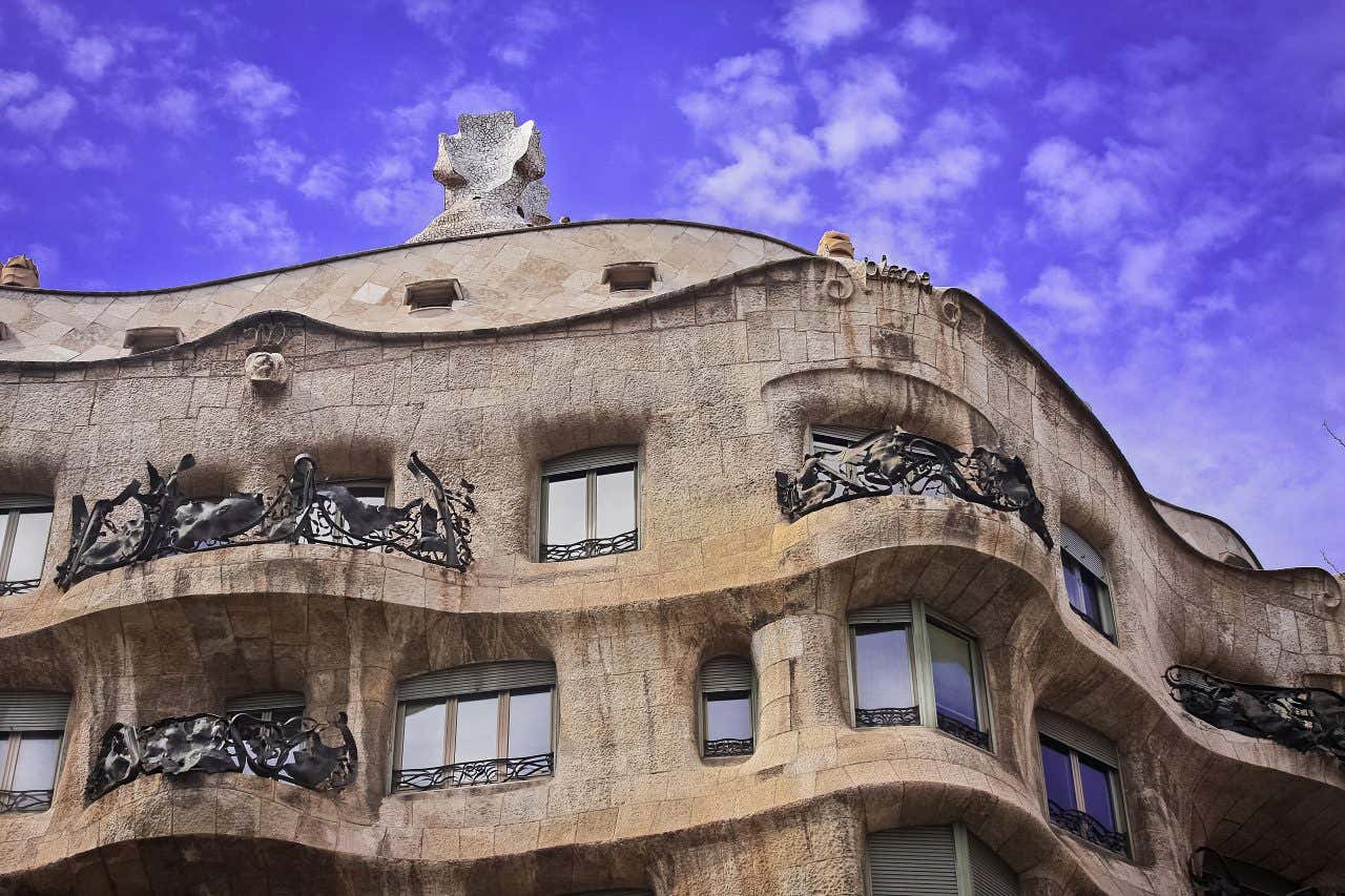 La Pedrera as seen from ground level, with its rooftop and wavey balconies in shot.