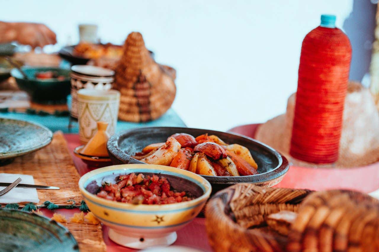 Various colourful plates of food set out on a table