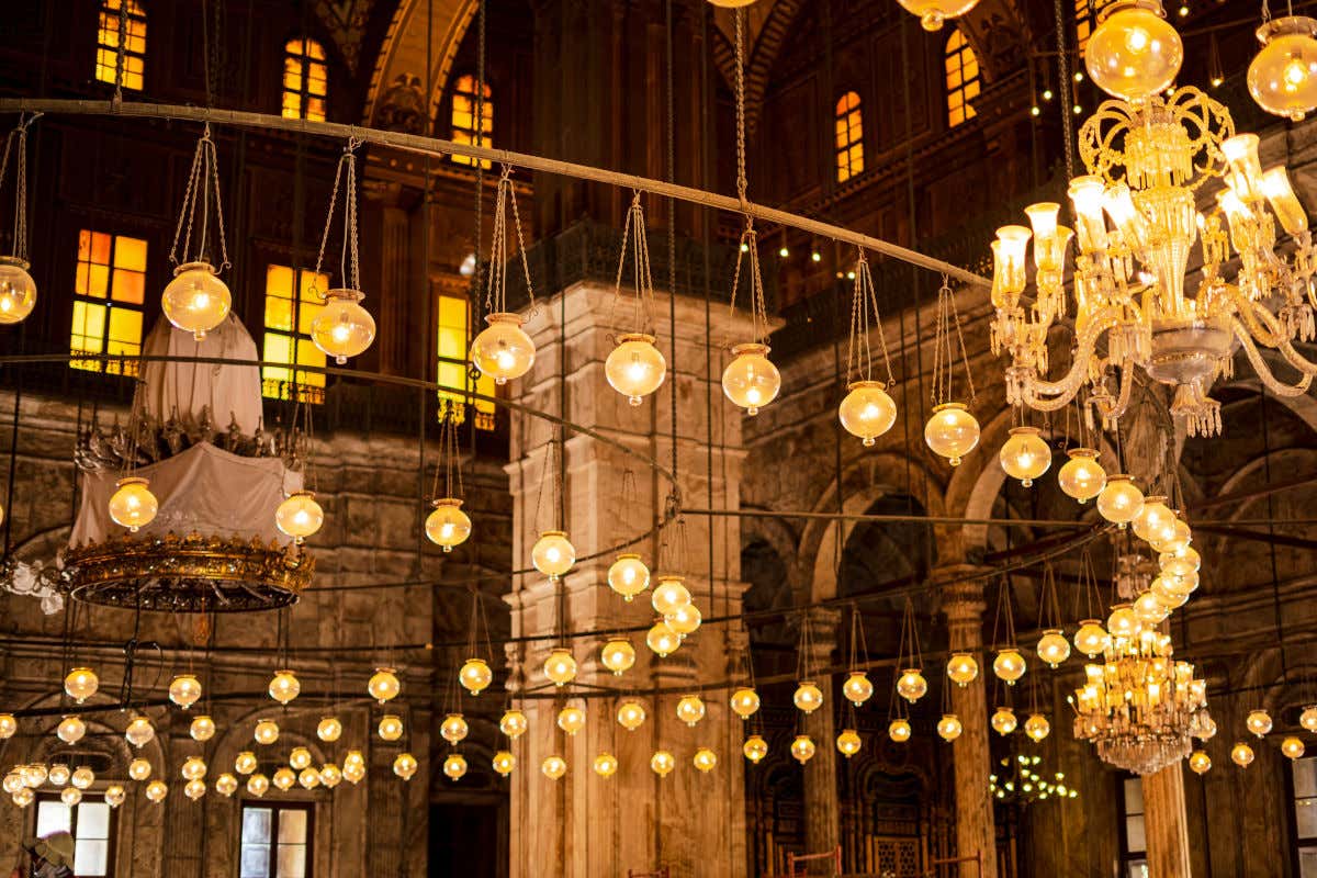 Interior of the Mohammed Ali Mosque or Alabaster Mosque filled with glass chandeliers.