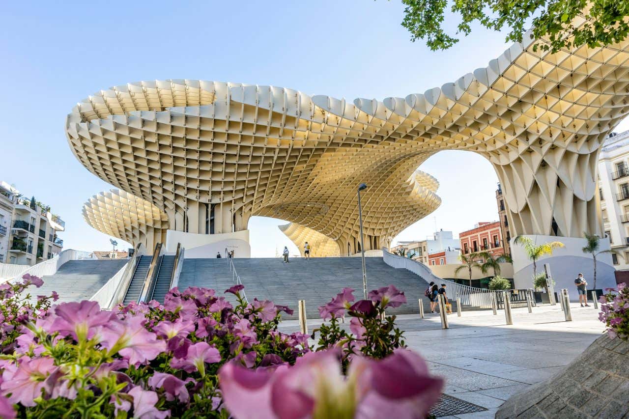 The Setas de Sevilla as seen during the day, from ground level, and with flowers in the foreground.