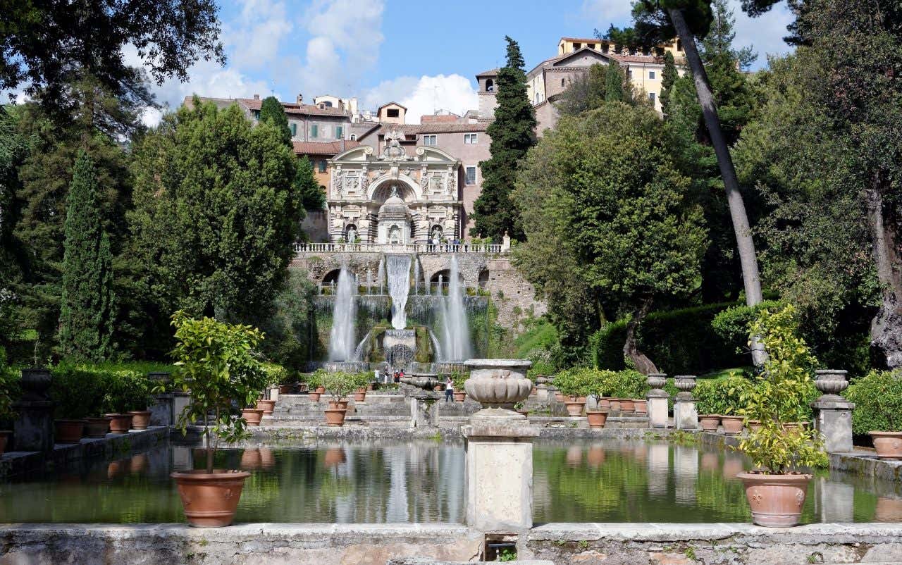 Villa d’Este near Rome, with a fountain in the foreground, and an ornate facade  in the background.