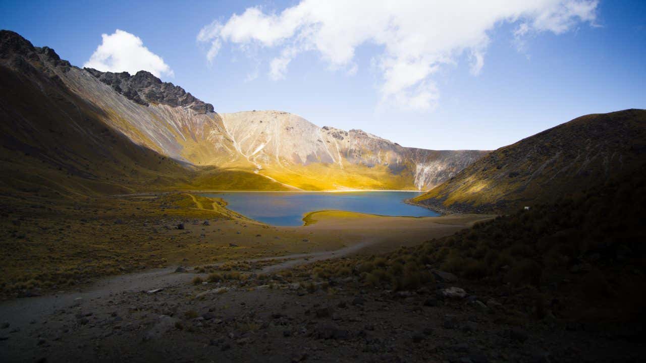 Nevado de Toluca landscape, with the sun shining on a mountain lake.