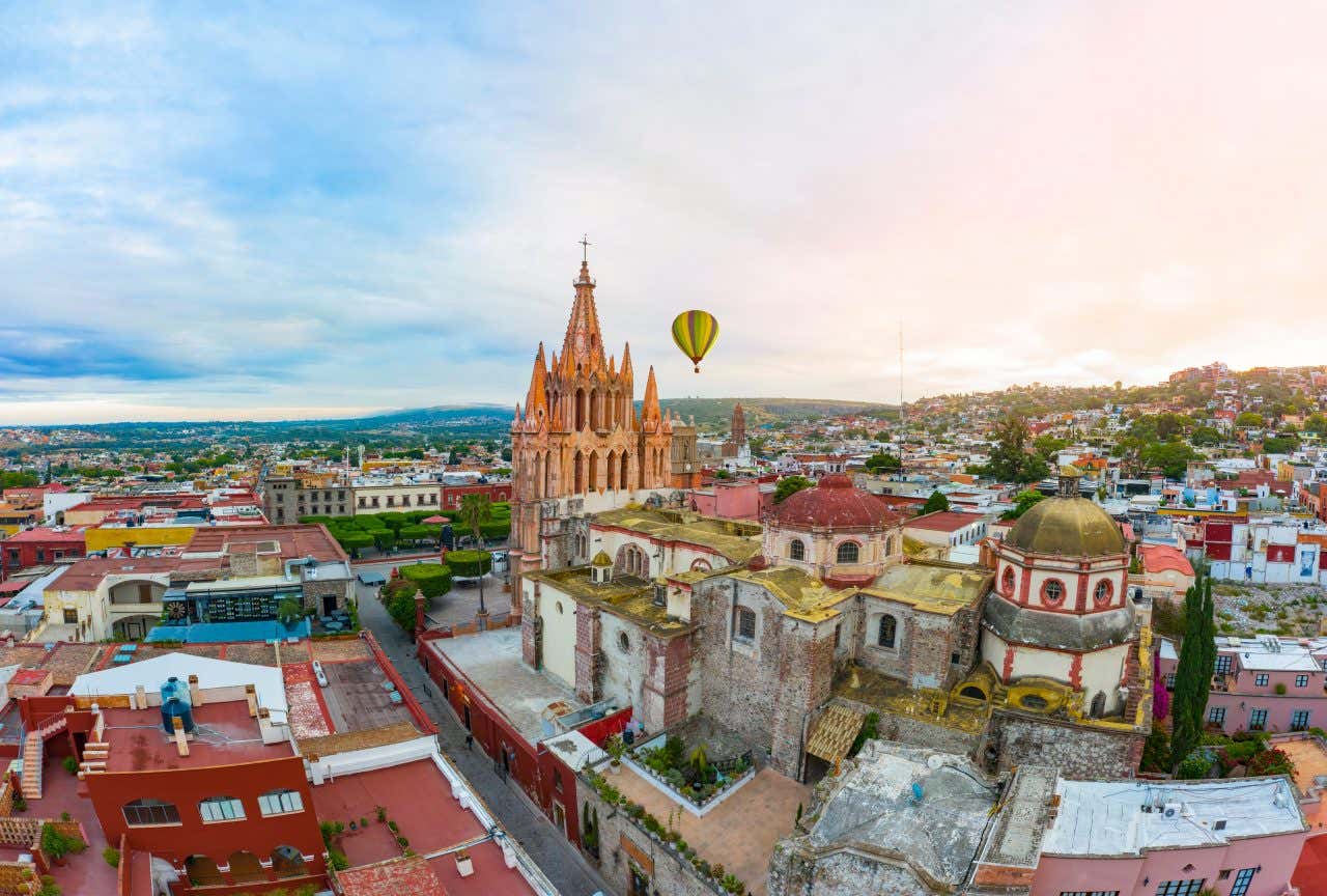 San Miguel de Allende as seen during the evening, with a pink and blue sky in the background.