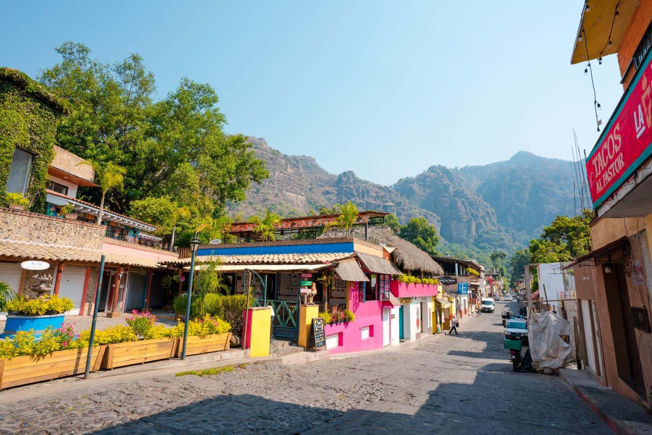 A street in Tepoztlán, with lots of colorful buildings along a narrow street.