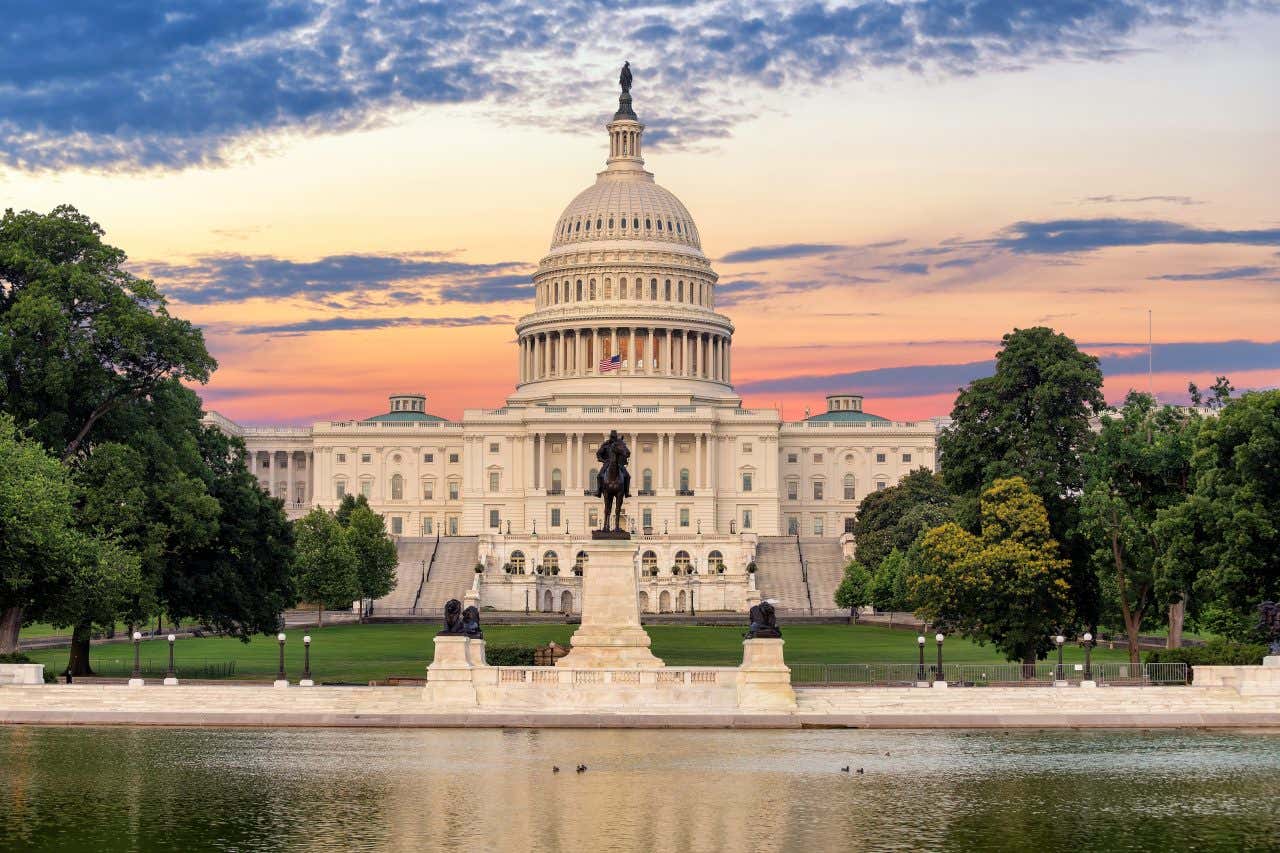 The Capitol building in Washington, D.C., with a cloudy evening sky in the background.