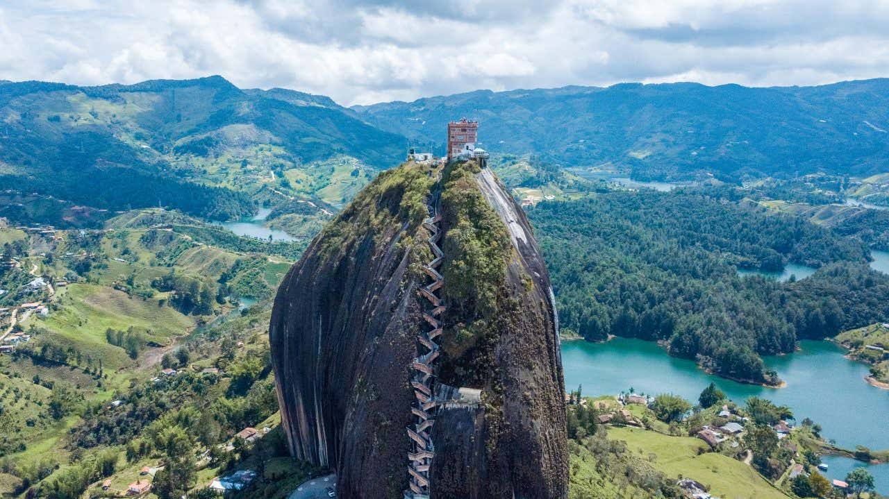 El Peñon de Guatapé seen from the sky, with a view of the landscape in the background.