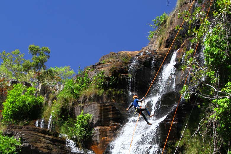 Someone rappelling down the waterfall