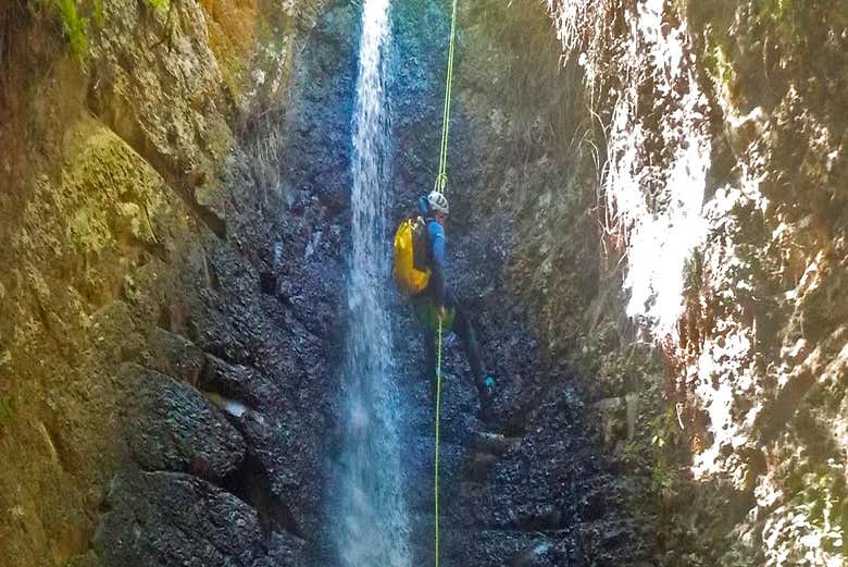 Abseiling down a waterfall during the activity