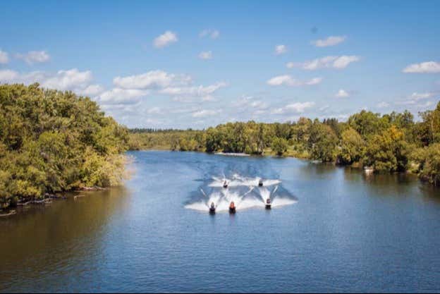 Various water mobiles speeding along the river