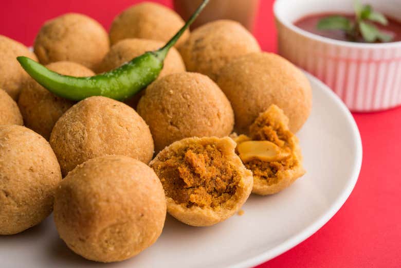 Tasting delicious Kachoris, or fried dumplings