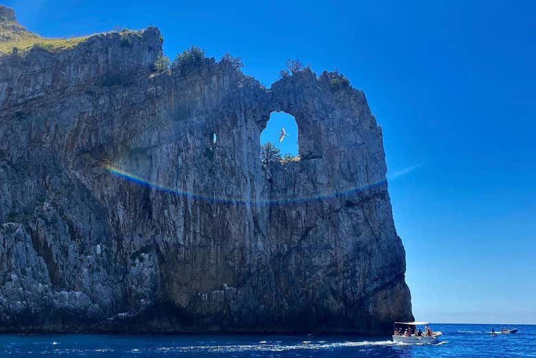 Sail past the Natural Arch monument in Palinuro