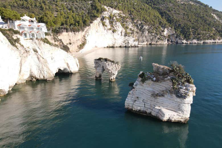 Sail by the iconic Baia delle Zagare and its famous cliffs